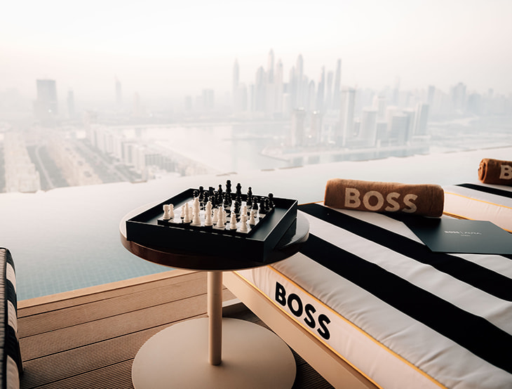 A chessboard with a sofa; in the background is a city with skyscrapers (photo)