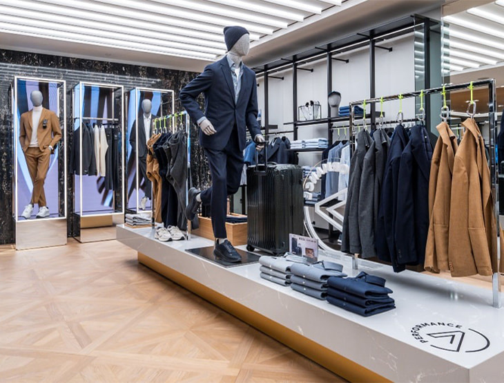 HUGO-BOSS store with shelves and products for men, styled in a warm, golden-bronze tone (photo)